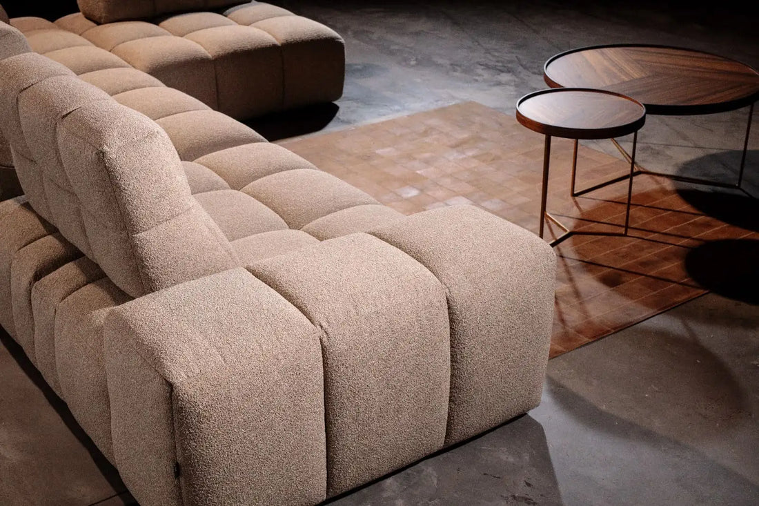 Beige tuftierter modulares Sektionalsofa mit texturierter Stoffoberfläche.